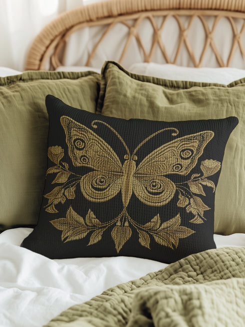 A black woven throw pillow featuring an embroidered gold Hamsa hand surrounded by intricate floral and botanical designs.